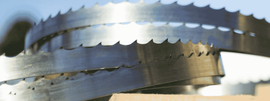 Close-up of coiled Wood-Mizer bandsaw mill blades with sharp induction-hardened teeth.